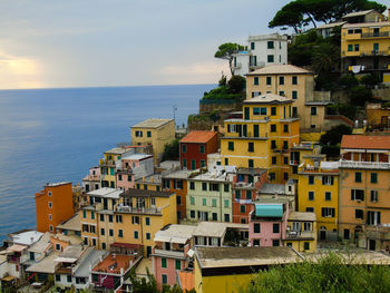 High angle view of townscape by sea against sky