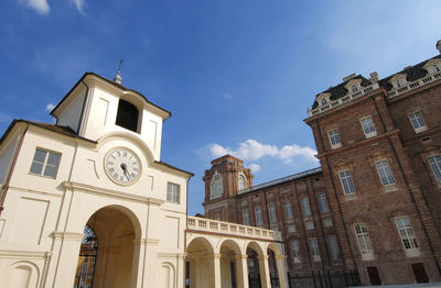 Low angle view of clock tower against sky