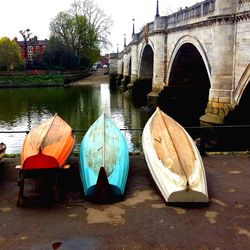 Boats in river against built structures