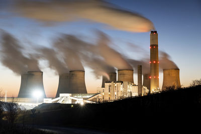 Uk, england, nottingham, long exposure of water vapor rising from cooling towers of coal-fired power station at dusk