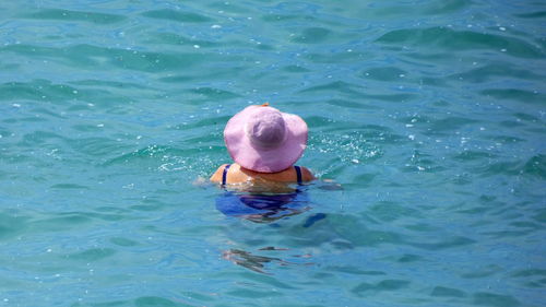 High angle view of man swimming in sea