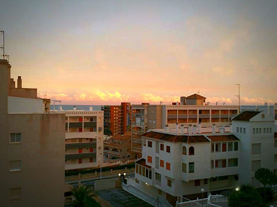 CITYSCAPE AGAINST SKY AT SUNSET