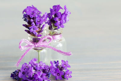 Close-up of purple flower vase on table