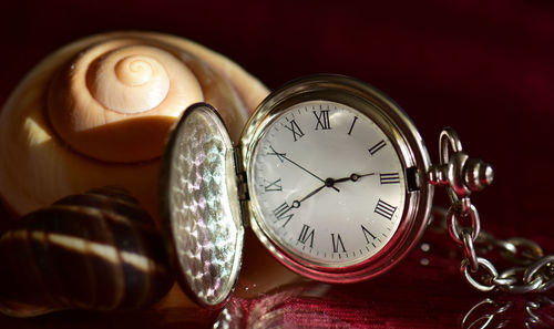 Close-up of pocket clock on table