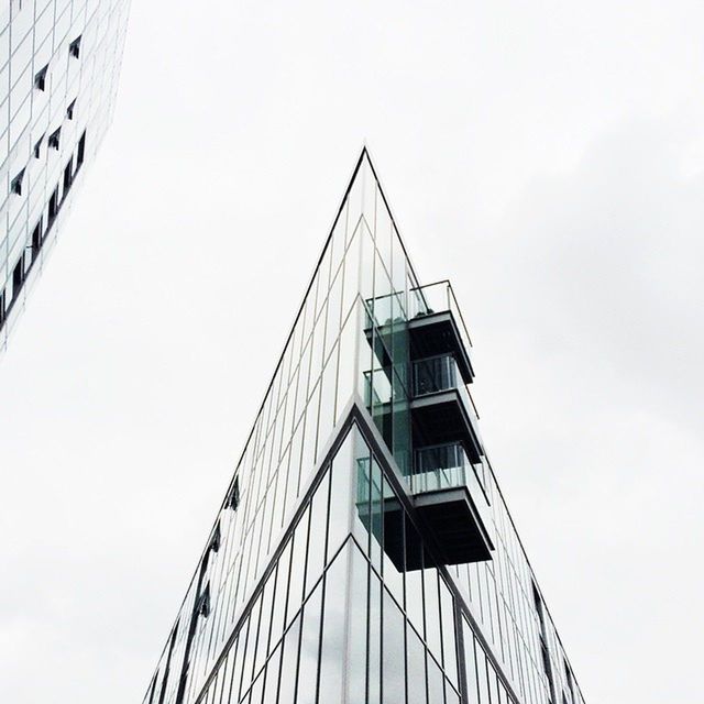 Low angle view of modern building against overcast sky