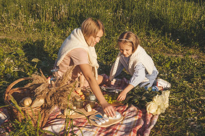 Girl and woman standing on field