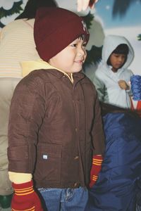 Close-up of smiling cute boy wearing warm clothing