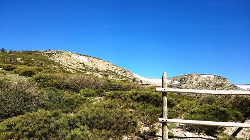 Scenic view of mountains against clear blue sky