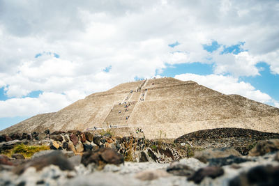 Surface level of rocks on land against sky