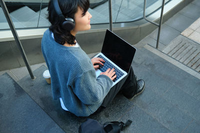 High angle view of woman using mobile phone