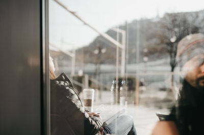 Portrait of man seen through glass window