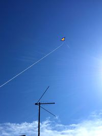 Low angle view of vapor trail against blue sky
