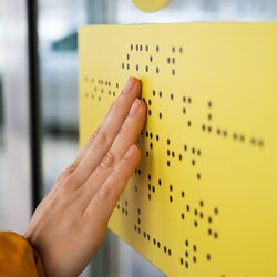 Cropped hand of person writing in book