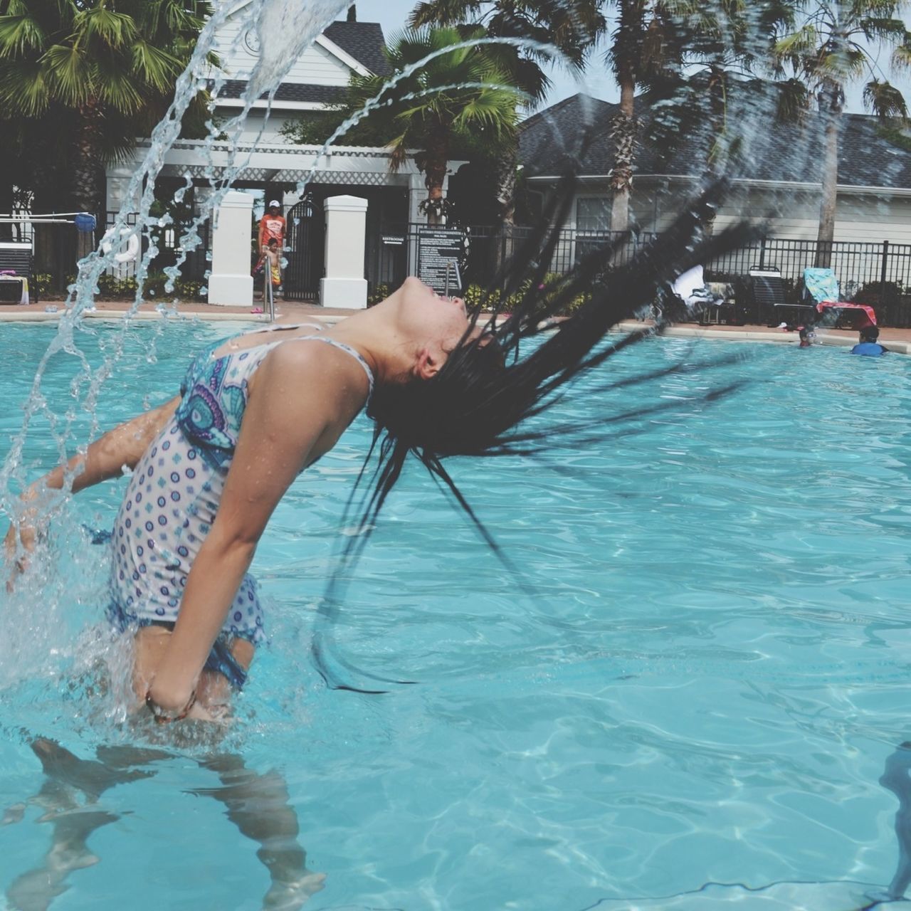 water, lifestyles, leisure activity, swimming pool, person, full length, waterfront, motion, holding, men, low section, enjoyment, barefoot, day, blue, built structure, fun