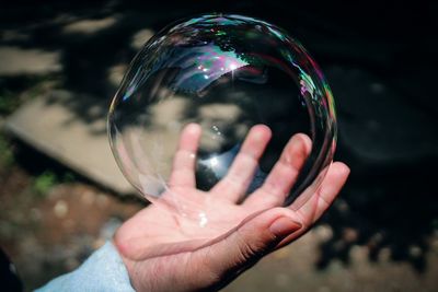 Close-up of person holding bubbles