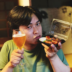 Portrait of woman holding ice cream in restaurant