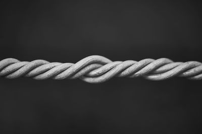 Close-up of rope against black background