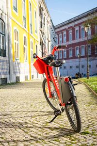 Bicycle on street against buildings in city