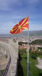 High angle view of flag by building against sky