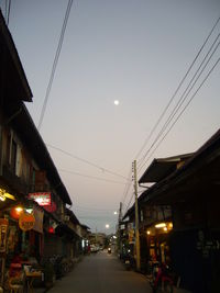 Illuminated street light on road at night