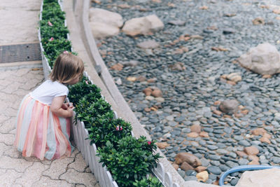 High angle view of girl on pebbles