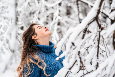 Portrait of young woman in snow