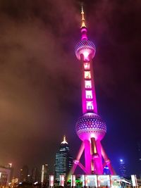 Low angle view of communications tower at night