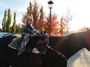 Woman standing by plants against sky