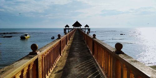 Pier over sea against sky