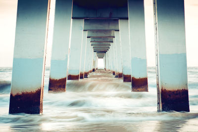 Digital composite image of building by sea against sky