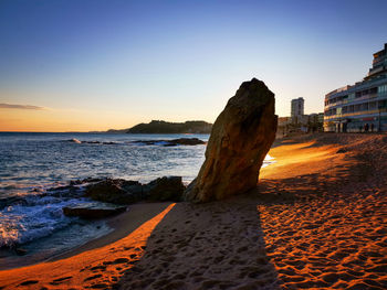 Scenic view of sea against clear sky during sunset