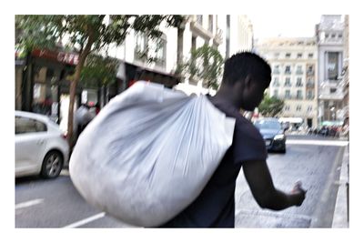 Rear view of man on street in city