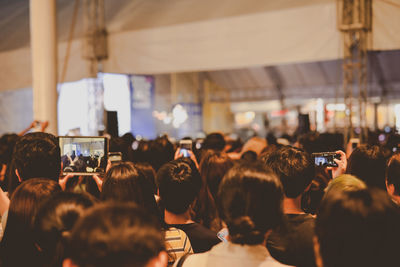 Nightlife and youth activity with backside of crowd in concert hall 