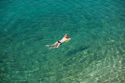 High angle view of man swimming in sea