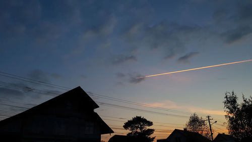 Low angle view of silhouette buildings against sky at sunset