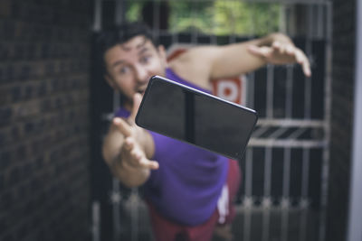 Midsection of man using mobile phone outdoors
