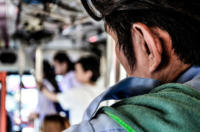 Cropped image of man traveling in bus