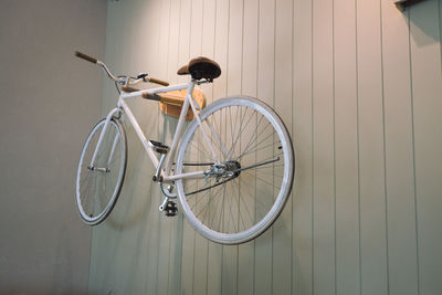 Bicycle parked against wall