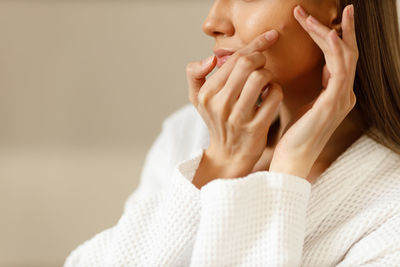 Close-up of young woman drinking water