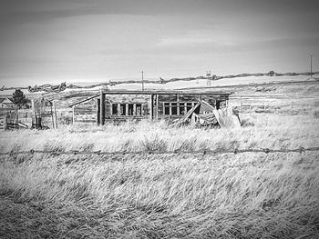 Abandoned built structure on landscape against sky