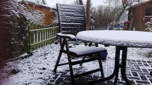 Snow covered chair in winter