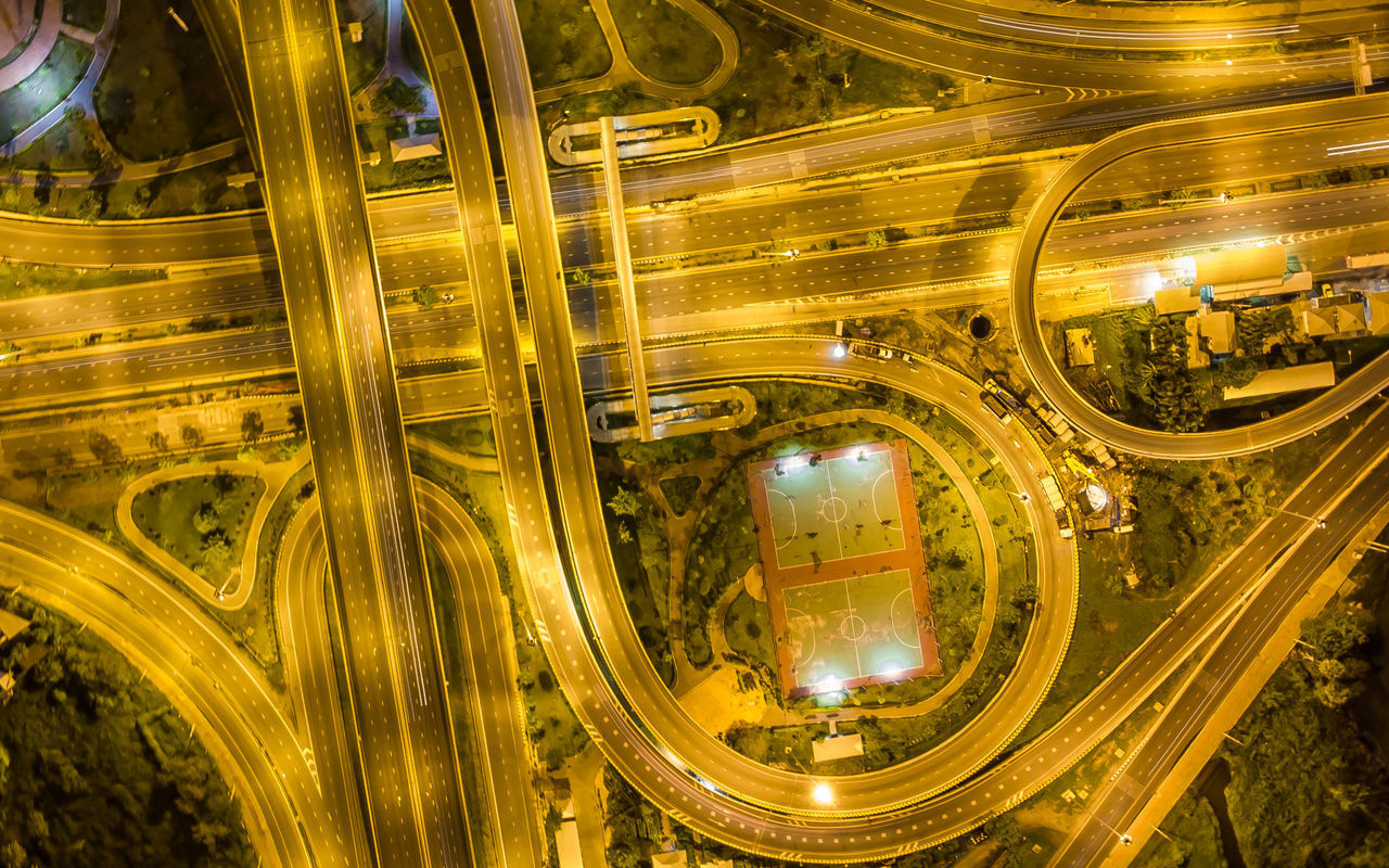 HIGH ANGLE VIEW OF LIGHT TRAILS ON ROAD