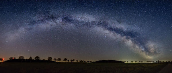 Scenic view of field against sky at night