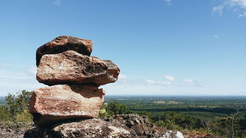 View of lizard on rock against sky