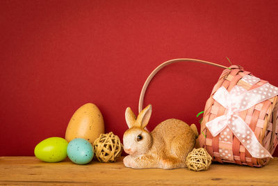 View of multi colored stuffed toy against red background