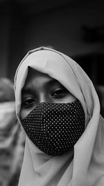 Close-up portrait of woman covering face