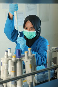 A chemist very carefully drops the ingredients that have been mixed in the laboratory into a drug