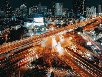 High angle view of light trails on city street amidst buildings