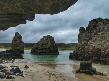Scenic view of rocks and sea against sky