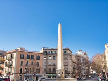 Low angle view of buildings against clear blue sky